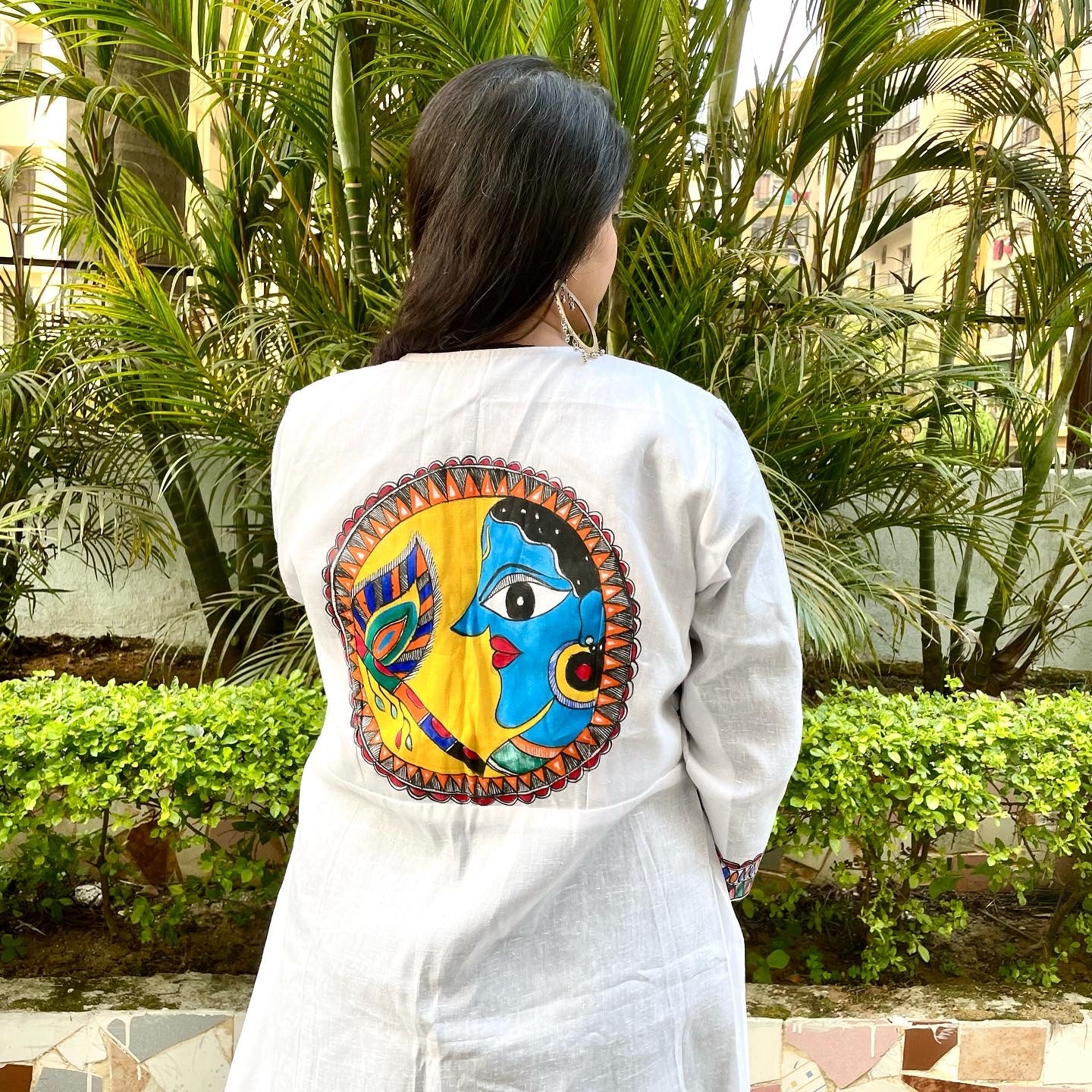 Handpainted madhubani art white base shrug with radha krishna motifs on front and krishna motif on back